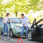 Stressed drivers near broken cars after accident